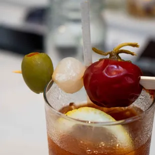 a drink with a cherry on a stick