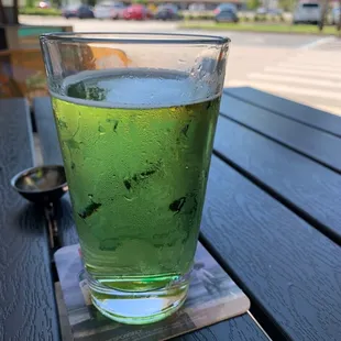 a glass of green liquid