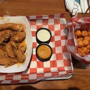 Buffalo tossed chicken tenders and a side of sweet potato tots