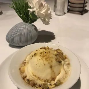 Homemade vanilla bean ice cream with bourbon syrup and toasted pistachios