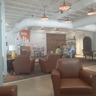 people sitting in chairs and tables