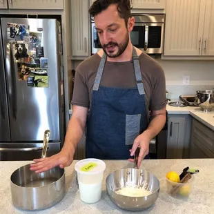 a man mixing ingredients in a bowl