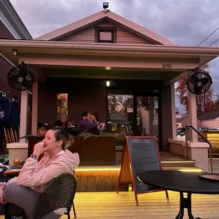 a woman sitting on a chair in front of a restaurant