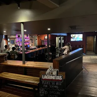a bar with people sitting at the bar