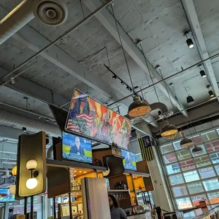 a restaurant with a bar and televisions