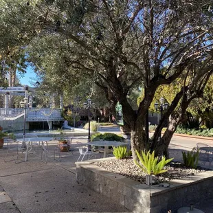 a patio with tables and chairs