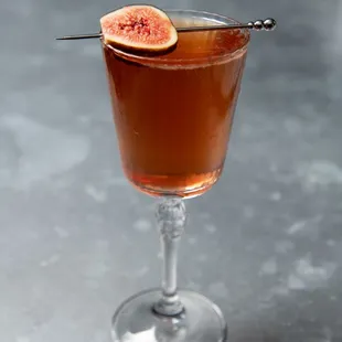 a glass of wine with figs on it