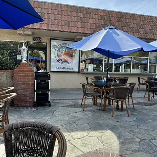 a patio with tables and umbrellas