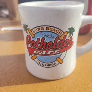 a white coffee mug with a logo on it