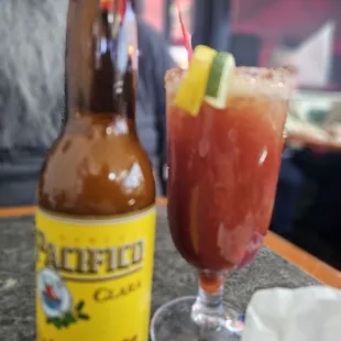Michelada served in a Bloody Mary glass and half glass of small ice cubes