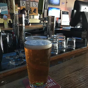 a pint of beer on a bar