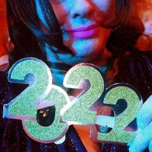 a woman holding a sign with the number twenty