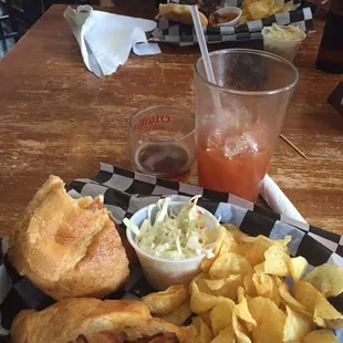 a plate of food with chips and a drink