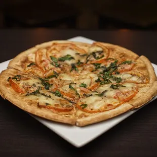 a small pizza on a square plate