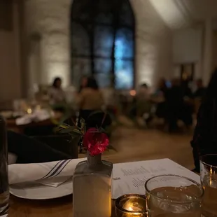 a candle and a vase with a flower in it