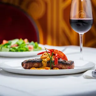 a plate of food and a glass of wine