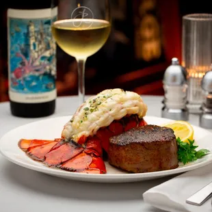 a plate of food and a glass of wine