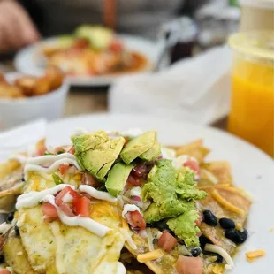 chilaquiles huevos rancheros  fresh squeezed orange juice cappuccino (not pictured apple streudel)