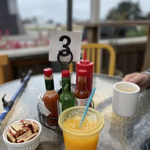a table full of condiments and drinks