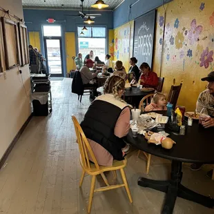 a group of people eating in a restaurant