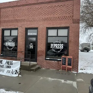 a brick building with a sign in front of it