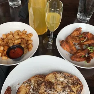 Peach mimosa, Nashville chicken wings, breakfast potatoes, turkey sausage.