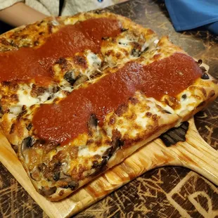 Detroit style pizza with pepperoni and mushrooms.