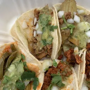 Vegan: Jackfruit carnitas, soyrizo, artichoke tacos, with onions, cilantro, and green sauce