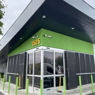 Front of building, chic corner sliding doors as the entrance