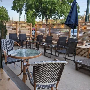 a patio with chairs and tables