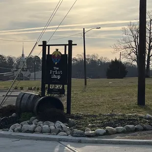 a sign with a barrel in the foreground