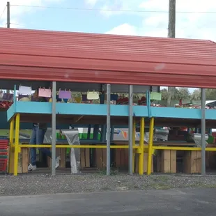 a fruit stand with a red roof