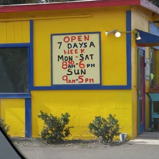 a yellow building with blue trim