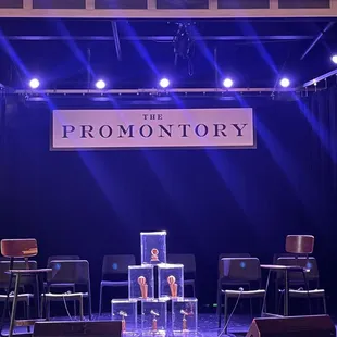 a stage with chairs and a podium