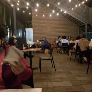 people sitting at tables in a restaurant
