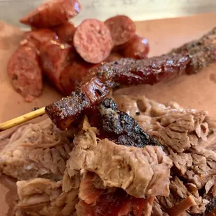 Brisket, bacon on a stick, links