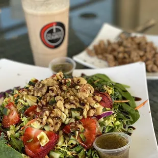 a plate of salad and a drink