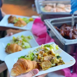 a person holding a plate of food