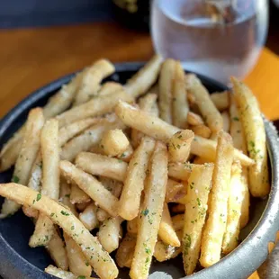 a bowl of french fries on a table