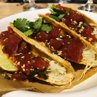 three tacos on a white plate