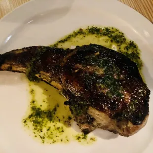 a piece of steak on a white plate