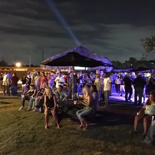 a large group of people sitting under umbrellas