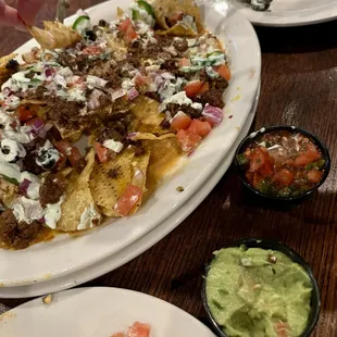 Nachos with beef. You can choose beef or chicken.   Salsa was meh. Guac was good! Nachos were loaded and yummy!