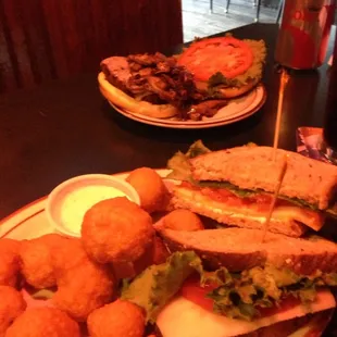 a sandwich and tater tots on a plate