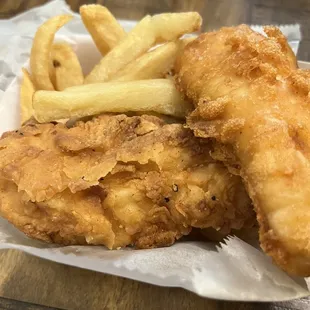 Surf and Turf 1 chicken finger 1 piece of fish and some fries