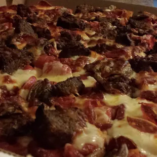 White pizza with pepperoni, meatballs, mushrooms, and extra cheese.