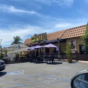 a parking lot with tables and umbrellas