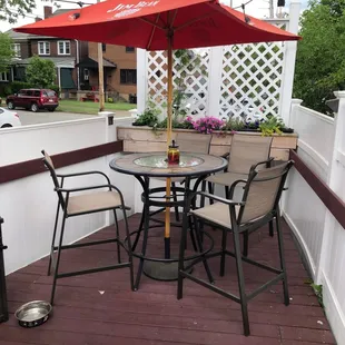 a patio with a table and chairs