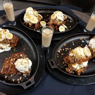 three plates of food and a glass of milk