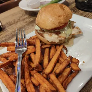a plate of french fries and a chicken sandwich